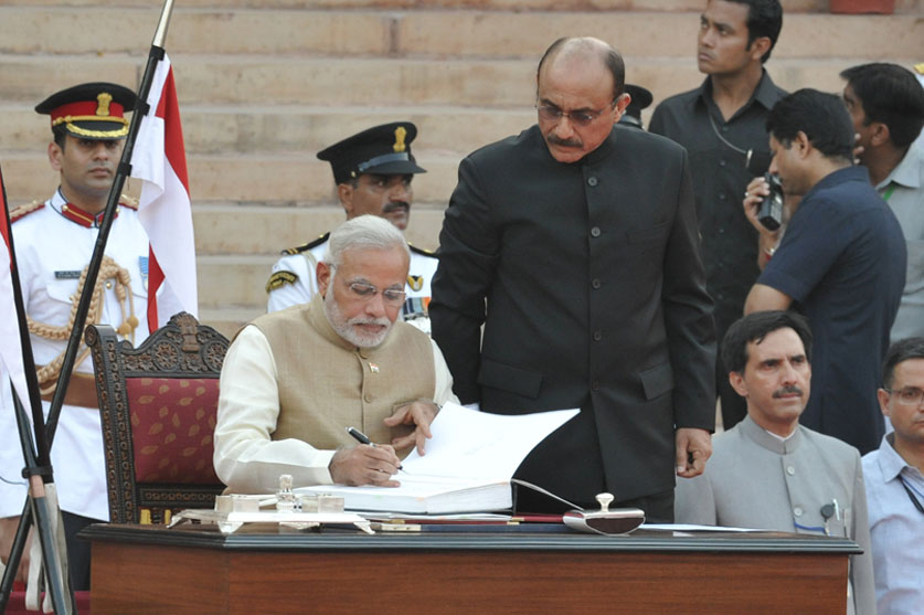 26 मई, 2014 को राष्ट्रपति भवन, नई दिल्ली में राष्ट्रपति प्रणब मुखर्जी द्वारा शपथ दिलाए जाने के बाद सरकारी रजिस्टर में हस्ताक्षर करते हुए प्रधान मंत्री नरेन्द्र मोदी